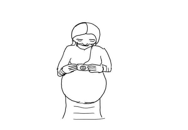 Pregnant woman holds a camera